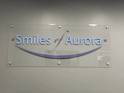 Smiles of Aurora logo hanging in the office
